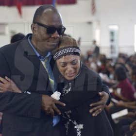 Gladstone Taylor/ Photographer

Sandra Morris-Allen (aunt in law) breaks down in tears after paying tribute to Annmarie and is consoled by Vincent Allen (step father) as she makes her way back to her seat.

funeral service for the life of Annmarie Elliott-Nesbeth held at the new life assembly of God in kingston on saturday march 12, 2016