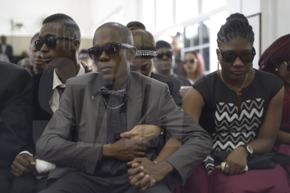 Gladstone Taylor/ Photographer<\n><\n>Lathan McCleary (brother), LeonHenry (uncle) and Shevene Allen (Step Sister) hold hands in support at the <\n>funeral service for the life of Annmarie Elliott-Nesbeth held at the new life assembly of God in kingston on saturday march 12, 2016