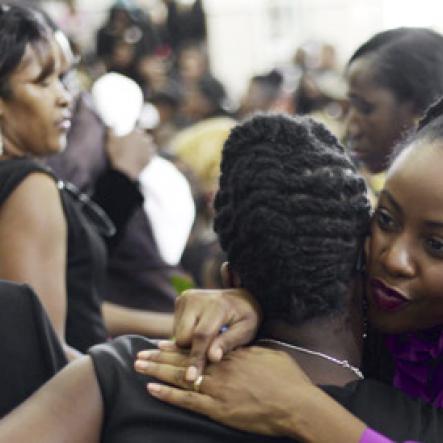 Gladstone Taylor/ Photographer<\n><\n>Empress Mullings (right) hugs Shevene Allen (step sister) at the funeral service for the life of Annmarie Elliott-Nesbeth held at the new life assembly of God in Kingston on Saturday march 12, 2016