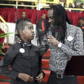Gladstone Taylor/ Photographer<\n>Sakani Nesbeth (son) and his father, Greg Nesbeth <\n>funeral service for the life of Annmarie Elliott-Nesbeth held at the new life assembly of God in kingston on saturday march 12, 2016