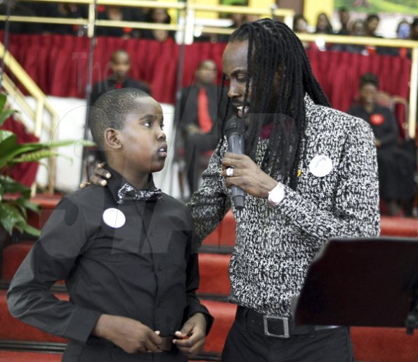 Gladstone Taylor/ Photographer<\n>Sakani Nesbeth (son) and his father, Greg Nesbeth <\n>funeral service for the life of Annmarie Elliott-Nesbeth held at the new life assembly of God in kingston on saturday march 12, 2016