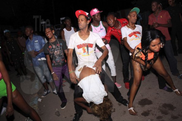 Anthony Minott/Freelance Photographer 
Ladies back-it-up for their male friends during Pon Di Spot Fridayz, Drewsland, in St Andrew recently.