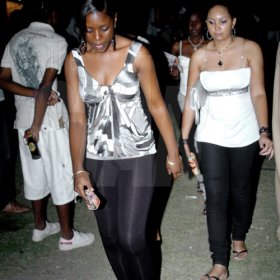 Winston Sill / Freelance Photographer
These two women seemed to have their minds elsewhere  while at Stir It Up  80s 90s Party, held at Louise Bennett Garden Theatre, Hope Road on Saturday night March.