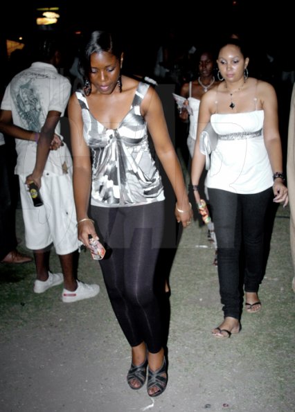 Winston Sill / Freelance Photographer
These two women seemed to have their minds elsewhere  while at Stir It Up  80s 90s Party, held at Louise Bennett Garden Theatre, Hope Road on Saturday night March.