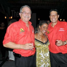 Photo by Janet Silvera
Summerfest Production's Johnny Gourzong (left) and Robert Russell get all the attention from the petite Jackie Norman during the Reggae Sumfest party at Pier One in Montego Bay on Thursday night.