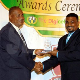 Colin Hamilton/Freelance Photographer
Anthony Cooke, Commissary of the Year accepts his award from Michael Ricketts at the Digicel Premier League and National U-21 Awards Ceremony held at the Jamaica Pegasus Hotel on Tuesday June 9, 2009.