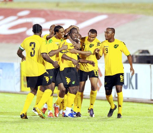 Ricardo Makyn/Staff Photographer.
Jamaica's Reggae Boyz surround goal scorer Devon Hodges (centre), after he scored the teams second goal in a 3-2 win over Panama at the national stadium last night.