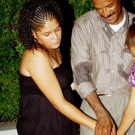 Winston Sill / Freelance Photographer
Capt. Errol Stewart celebrates  his 50th birthday with a grand swinging party, held at JDF Officers Club, Up Park Camp on Saturday night August 29, 2009. Here Capt. Stewart (centre) and his daughters-- Kayla Stewart (left); and Brianne Stewart (right) cuts the birthday cake.