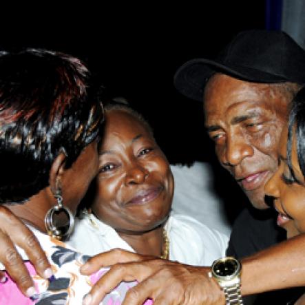 Winston Sill / Freelance Photographer
                                                                                     Nothing like a group hug to 'Stir Up' the party vibes.                                                                                                                                                                                                                                                                                      , held at Palisadoes Go-Kart Track, Norman Manley Airport on Saturday night March 26, 2011.