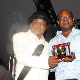 Publication: Daily Star
Photo by Noel Thompson

Tito Jackson (left), brother of the late King of Pop, Michael Jackson, presents a special award to Tourism Minister, Ed Bartlett, which the Jackson family has given to the people of Jamaica. The presentation took place at Reggae Sumfest International NIght Two on Saturday (July 25, 2009) in Catherine Hall, Montego Bay.  Summerfest Productions and the Jamaican government, as well as artist Jeffrey Samuels, also made presentations to Tito.