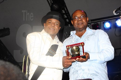 Publication: Daily Star
Photo by Noel Thompson

Tito Jackson (left), brother of the late King of Pop, Michael Jackson, presents a special award to Tourism Minister, Ed Bartlett, which the Jackson family has given to the people of Jamaica. The presentation took place at Reggae Sumfest International NIght Two on Saturday (July 25, 2009) in Catherine Hall, Montego Bay.  Summerfest Productions and the Jamaican government, as well as artist Jeffrey Samuels, also made presentations to Tito.