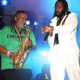Publication: Daily Star
Photo by Noel Thompson

Tarrus Riley, keeps time on his watch to see how long saxophonist Dean Frazer can blow his instrument, during a performance at Reggae Sumfest International Night Two on Saturday (July 25, 2009) in Catherine Hall, Montego Bay. Riley's act outclassed several others for that night.