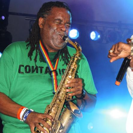 Publication: Daily Star
Photo by Noel Thompson

Tarrus Riley, keeps time on his watch to see how long saxophonist Dean Frazer can blow his instrument, during a performance at Reggae Sumfest International Night Two on Saturday (July 25, 2009) in Catherine Hall, Montego Bay. Riley's act outclassed several others for that night.