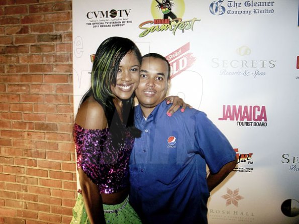 Contributed                                                                                                                                                                  Carlo Redwood (right), Head of Marketing for Pepsi gets a hug from entertainer Denique at the launch of Reggae Sumfest on Wednesday at Devon House.