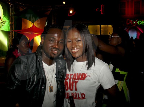 Performer I-Octane relaxes with Safia Cooper, brand manager Red Stripe during the launch of Reggae Sumfest at Devon House on Wednesday June 29th.