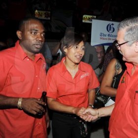 Contributed
Red Stripe's Dave DaCosta (left) and Lisa Lewis greet Robert Russell, director of Summerfest Productions during the launch of Reggae Sumfest on Friday at the SportsMax Sports Zone on Trafalgar Road.