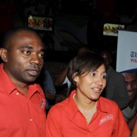 Contributed
Red Stripe's Dave DaCosta (left) and Lisa Lewis greet Robert Russell, director of Summerfest Productions during the launch of Reggae Sumfest on Friday at the SportsMax Sports Zone on Trafalgar Road.