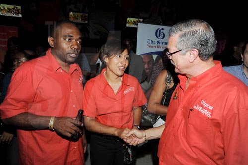 Contributed
Red Stripe's Dave DaCosta (left) and Lisa Lewis greet Robert Russell, director of Summerfest Productions during the launch of Reggae Sumfest on Friday at the SportsMax Sports Zone on Trafalgar Road.