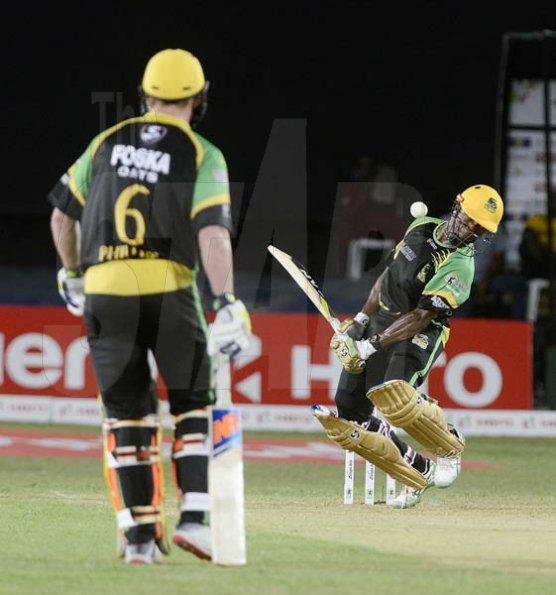 Ian Allen/PhotographerAndre McCarthy (right) evades a bouncer from a St.Lucia Stars bowler during the Jamaica Tallawahs reply to 175. Looking on is Glen Phillips.