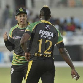 Ian Allen/PhotographerAndre Russell (right) and Ross Taylor (left) strategising during the CPL T/20 cricket match between the Jamaica Tallawahs and the St.Lucia Stars at Sabina Park on Tuesday.