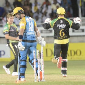 Ian Allen/PhotographerGlen Phillips ( right) and Adam Zampa (left) Jamaica Tallawahs team mates celebrate the dismissal of Chapman (center) from the St.Lucia Stars during their Caribbean Premier League (CPL) T/20 cricket match at Sabina Park on Tuesday.