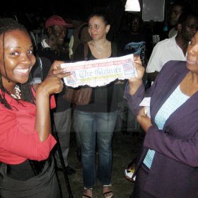 Mel Cooke photo
 
A thrilled Kennise Watson (left) shows her Thursday Gleaner masthead to an approving Gleaner (PLEASE PUT IN TITLE) Mary Dick, after winning a ticket to Jamaica Jazz and Blues 2010 on Thursday evening. Watson paid $20.10 for the ticket with 41 coins, beating out four other contestants who came up with fewer coins for the stipulated ticket price at The Gleaner's free pre-festival event.