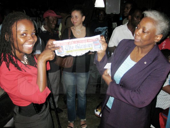 Mel Cooke photo
 
A thrilled Kennise Watson (left) shows her Thursday Gleaner masthead to an approving Gleaner (PLEASE PUT IN TITLE) Mary Dick, after winning a ticket to Jamaica Jazz and Blues 2010 on Thursday evening. Watson paid $20.10 for the ticket with 41 coins, beating out four other contestants who came up with fewer coins for the stipulated ticket price at The Gleaner's free pre-festival event.