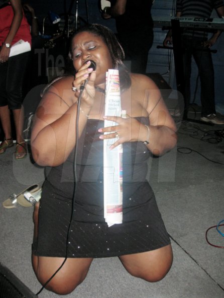 Mel Cooke photo
 
Vanessa gets down on her knees to sing thanks to her dance 'partner', a copy of The Gleaner, and warble his telephone number at the free pre-Jamaica Jazz and Blues concert held at The Deck, Trafalgar Road, New Kingston, last Thursday night.