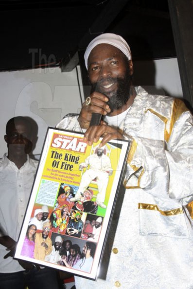 Capleton shows off his plaque from THE STAR