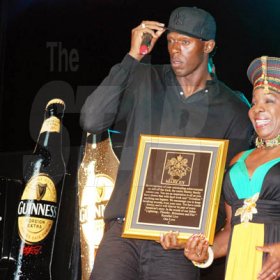 Janet Silvera 
Rita Marley (right) presents a plaque to Usain Bolt at his 9.58 Super Party at Richmond Estate, St Ann last Saturday night.