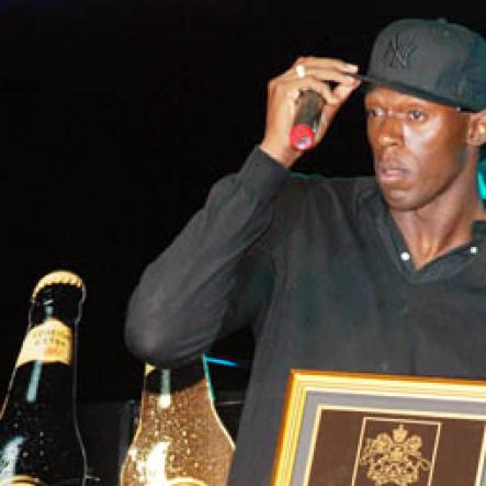 Janet Silvera 
Rita Marley (right) presents a plaque to Usain Bolt at his 9.58 Super Party at Richmond Estate, St Ann last Saturday night.