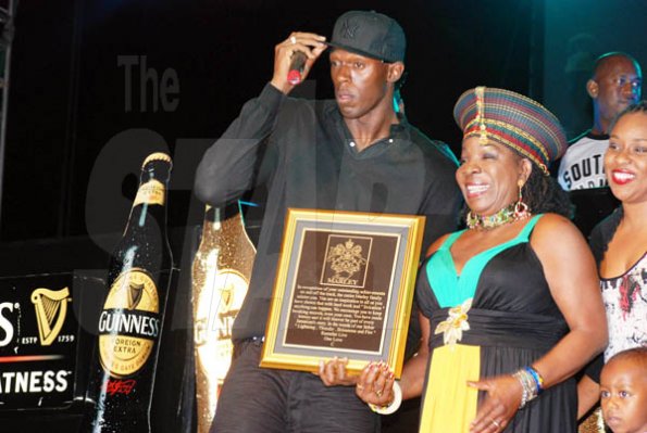 Janet Silvera 
Rita Marley (right) presents a plaque to Usain Bolt at his 9.58 Super Party at Richmond Estate, St Ann last Saturday night.