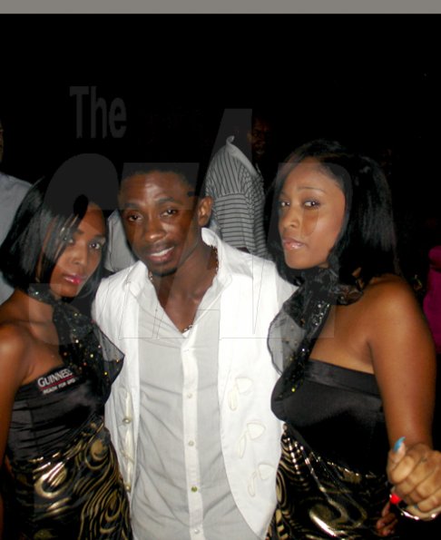 Contributed
Entertainer Christopher Martin hangs out with the Guinness girls during the Bolt party 9.58 at Richmond Estate St. Ann on Saturday night December 5th.
