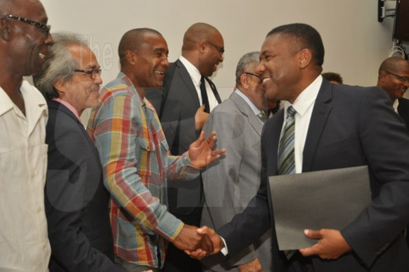 Jermaine Barnaby/Photographer
Phillip Paulwell (right) Minister of Science, Technology, Energy and Mining meeting with members of the Cannis Commercial and Medical Research Task force at the launch for the symbolic planting of the first legal Marijuana Plant at the Lecture Theatre Two (2) , Faculty of Medical Sciences Teaching and Research Complex on Monday April 20, 2015. Here he greets Courtney Betty, president and CEO, Timeless Herbal Care.