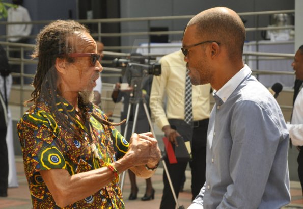 Jermaine Barnaby/Photographer
Frank Dowding (left) speaks with Raymond Pryce about some ganja issues at the launch for the symbolic planting of the first legal Marijuana Plant at the Lecture Theatre Two (2) , Faculty of Medical Sciences Teaching and Research Complex on Monday April 20, 2015.