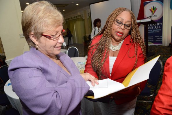 Rudolph Brown/Photographer
Dr.Denise Chevannes, (right) Executive Director, National Family Planning Board(NFPB) chat with Dr Carolyn Gomes of the Caribbean Vulnerable Communities at the World AIDS Day breakfast Forum "Health for All: Towards A More Integrated Response to HIV Prevention, Treatment and Care, at the Knutsford Court Hotel on Tuesday, December 1, 2015