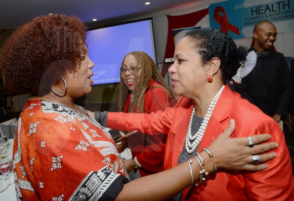 Rudolph Brown/Photographer
Kate Spring, (right) Country Director of UNAIDS greets Taitu Heron, (left) National Programme Coordinator, Jamaica of UN Women at the World AIDS Day breakfast Forum "Health for All: Towards A More Integrated Response to HIV Prevention, Treatment and Care, at the Knutsford Court Hotel on Tuesday, December 1, 2015