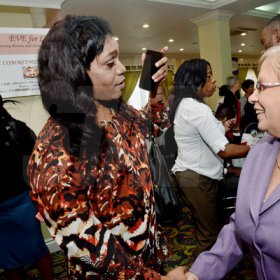 Rudolph Brown/Photographer
Transwoman Jessica Burton, (left) chat with Dr Carolyn Gomes of the Caribbean Vulnerable Communities at the World AIDS Day breakfast Forum "Health for All: Towards A More Integrated Response to HIV Prevention, Treatment and Care, at the Knutsford Court Hotel on Tuesday, December 1, 2015