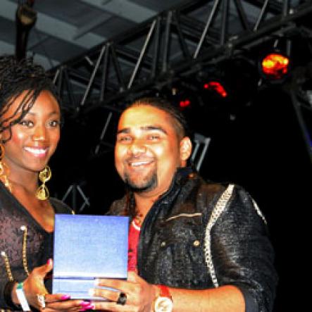 Winston Sill / Freelance Photographer
                                                                      Dancer Mystic Davis (left) collects her award from Romeich Major, while Yendi Phillipps looks on.